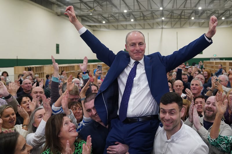 Fianna Fail leader Micheal Martin is hoisted up by his sons Cillian and Micheal Aodh, after he was deemed elected in the Cork South Central constituency. Jacob King/PA Wire