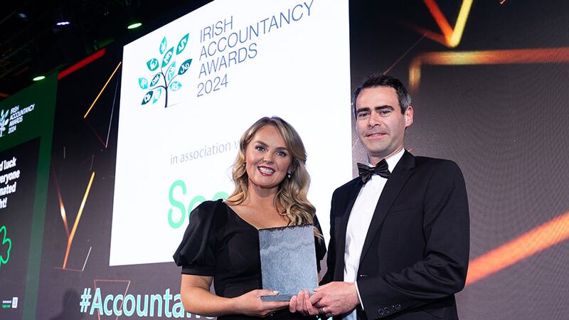 Niamh Griffin, Business Banking Manager ptsb, presents the advisory team of the year award to Dessie Morrow, Azets ireland.