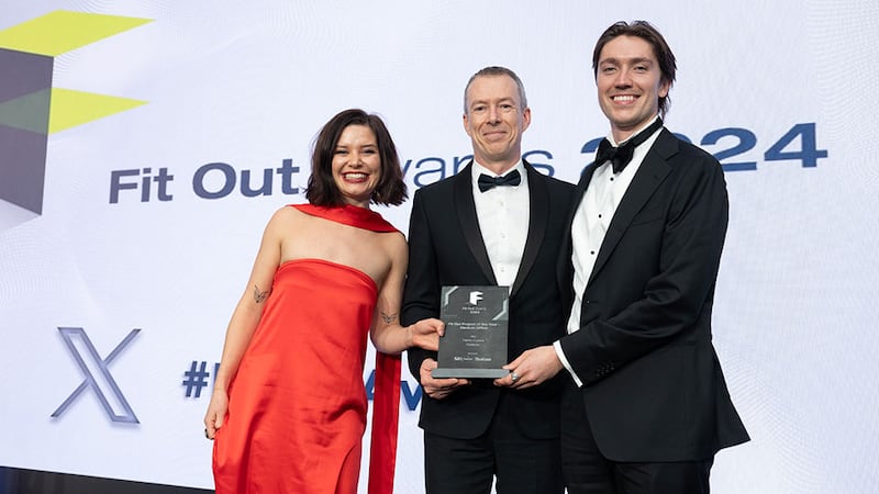 JP Rust, managing director of SIG Workplace, presents the fit out project of the year - medium office award to Eva Williams and Samuel Owen, Henry J Lyons