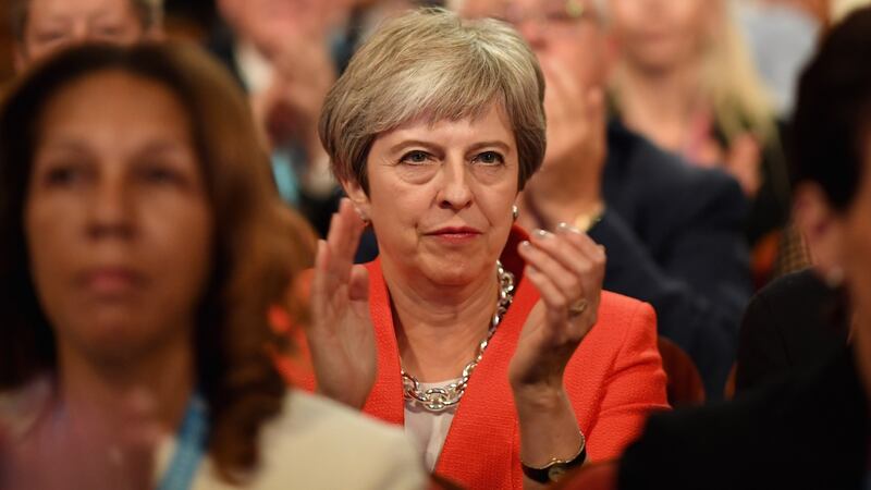 Theresa May applauds as she sits in the audience during the annual Conservative Party Conference on Sunday in Birmingham, England. Photograph: Jeff J Mitchell/Getty Images