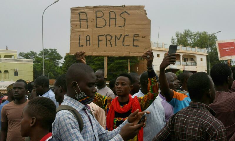 A man holds a placard reading `Down with France' as people demonstrate against the French military presence in Niger on September 18th, 2022, in Niamey.  Photograph: Boureima Hama/Getty Images