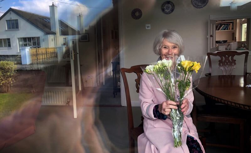 FRESH FRESIAS FOR MUM: Ellen Creed, of Dublin, with a bunch of flowers that was left outside her door, due to coronavirus "cocooning" of older persons, on Mother's Day. Photograph: Bryan O'Brien