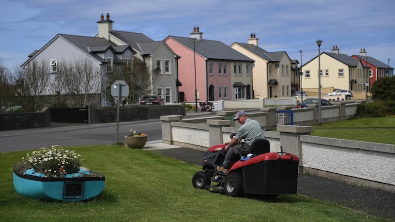 A local man mows the grass to tidy up Doonbeg village. Photograph: Clodagh Kilcoyne/Reuters