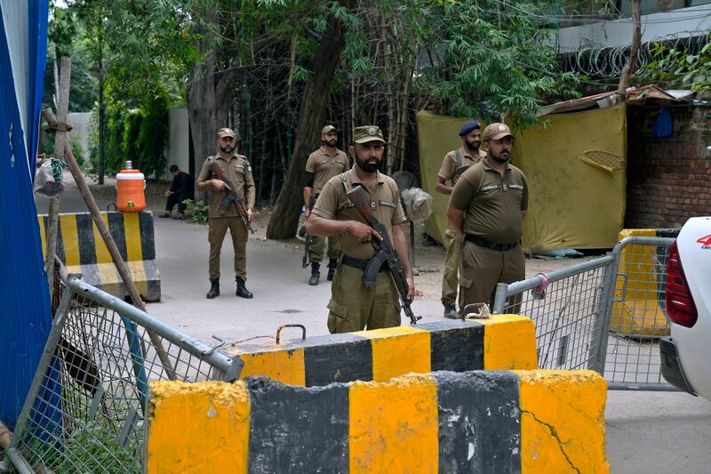 Police officers stand guard outside the residence of Pakistan’s former prime minister Imran Khan in Lahore on Saturday. Photograph: KM Chaudary/AP