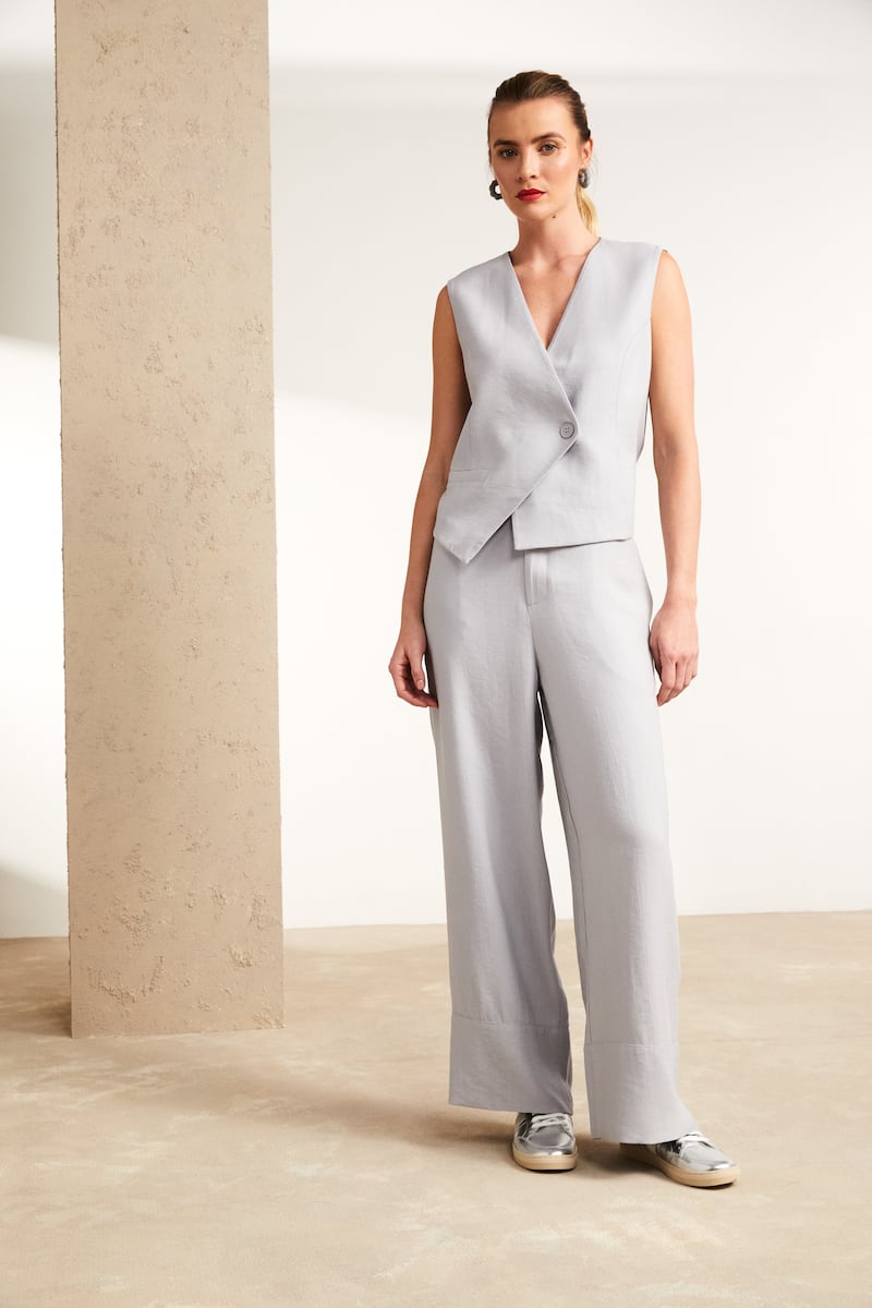 Asymmetric waistcoat with button, €154; wide-leg trousers, €129