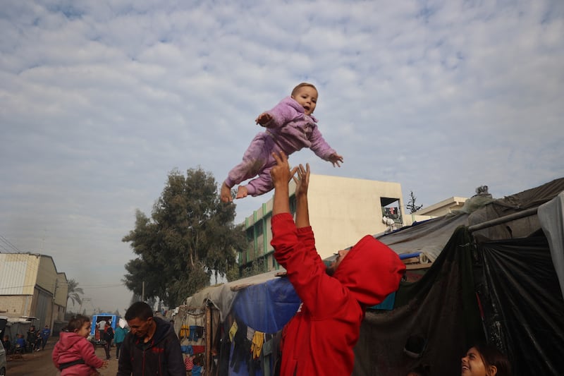 Displaced Palestinians outside their tents in Deir al-Balah in the central Gaza Strip . Photograph: Eyad Baba/AFP via Getty Images