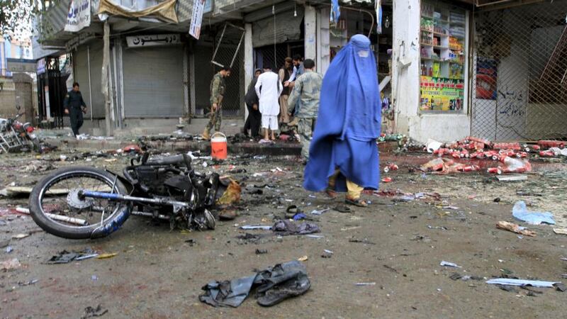 An Afghan woman walks at the site of a suicide attack in Jalalabad, Afghanistan. Photograph: Parwiz/Reuters