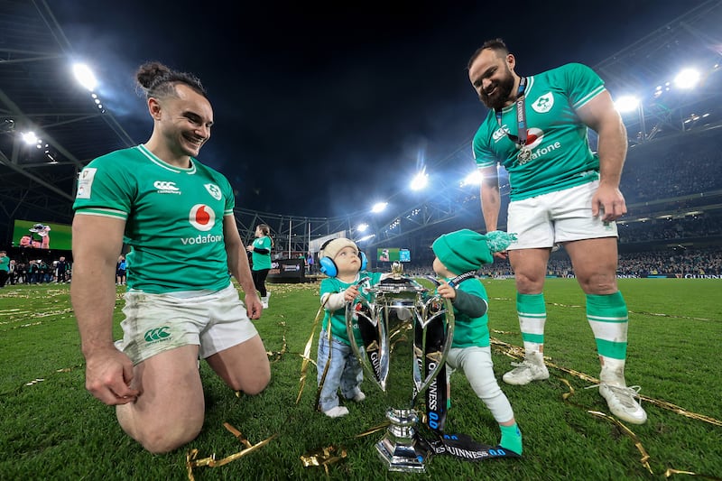 James Lowe and Jamison Gibson-Park with their sons, Nico and Jai, after Ireland's win over Scotland to claim the 2024 Six Nations title. Photograph: Dan Sheridan/Inpho