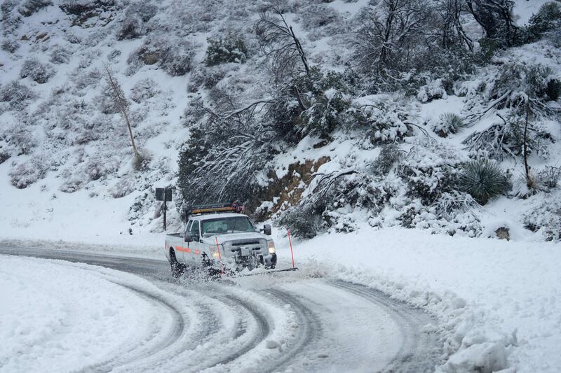 A plow clears the road for travel on the Angeles Crest Highway during a blizzard in the San Gabriel Mountains near Los Angeles, California on February 24th. Photograph: Allison Dinner/AFP via Getty