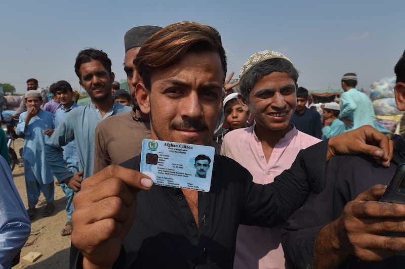 Afghan refugees show their registration cards in Karachi after the Pakistani government's deadline to expel illegal immigrants passed. Photograph: Shahzaib Akbar/EPA/EFE