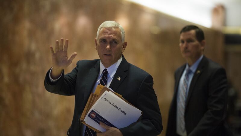 US vice president-elect Mike Pence waves to members of the media while arriving at Trump Tower in New York  on Friday Photograph: John Taggart/Bloomberg