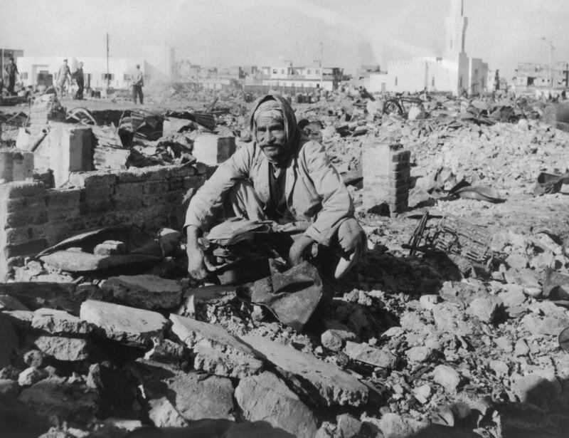 An elderly man searches through the ruins of his home in Port Said during the Suez Crisis in 1956. Photograph: Hulton Archive/Getty Images