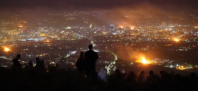 People look out from Cavehill across Belfast city of loyalist bonfires burning during Twelfth commemorations marking the anniversary of the Protestant King William's victory over the Catholic King James at the Battle of the Boyne in 1690. Photograph: Niall Carson/PA