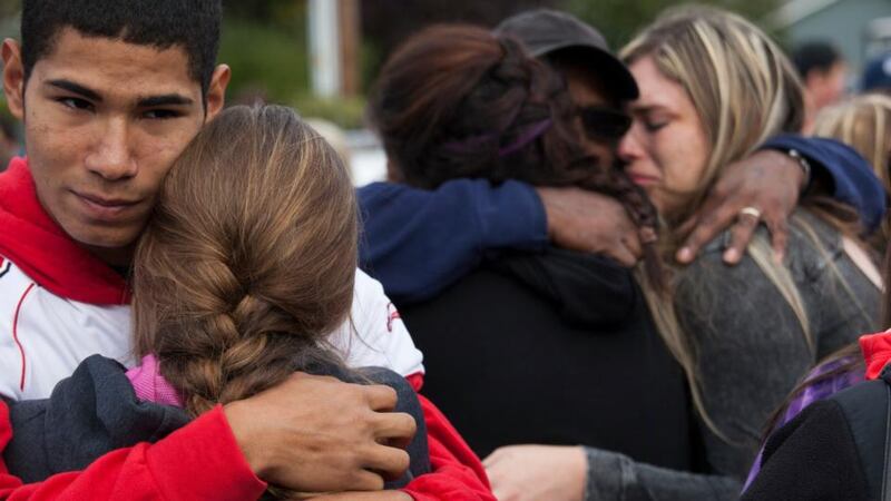 Students and family members embrace after leaving Marysville-Pilchuck High School in the aftermath of a shooting on the high school’s campus yesterday. Photograph:  David Ryder/Getty Images