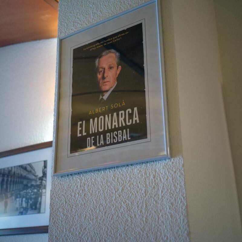 The cover of Albert  Solà’s autobiography hangs in the pub where he works as a waiter. Photograph: Samuel Aranda/New York Times