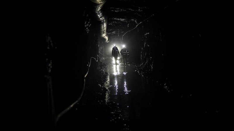 Miners in a puddle-filled tunnel in the Cononish gold mine near Tyndrum. Photograph: Mary Turner/The New York Times