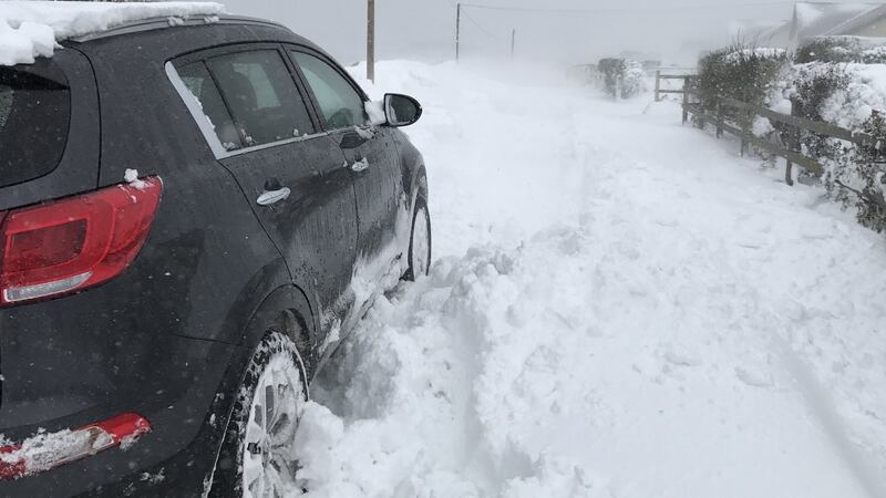 A car tries to navigate a snow-covered road in Kinsale, Co Cork, on Thursday. Photograph: Sarah and Cillian Fitzgerald