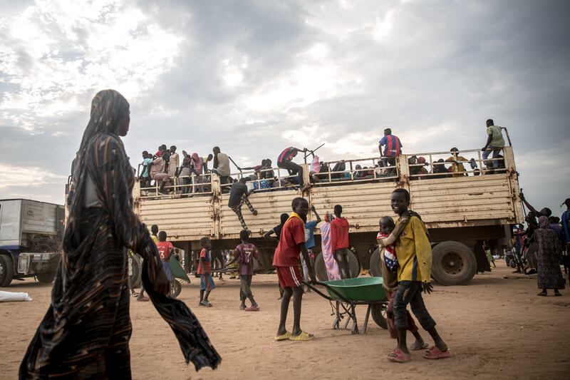 People fleeing Sudan's devastating war disembark from trucks at a transit centre in Renk, South Sudan. Photograph: Sally Hayden