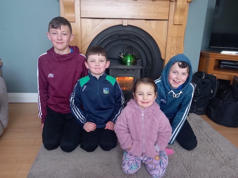 Sean, Jamie, Chloe and Dylan O'Dwyer in front of the solid fuel stove, which is the family's only source of heat over the current cold snap