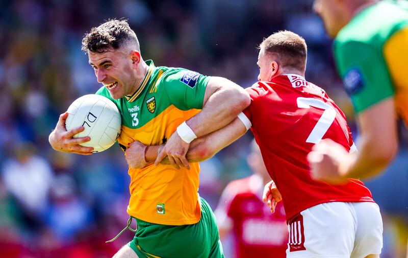 Donegal's Brendan McCole tries to fend off Matty Taylor of Cork. Photograph: Nick Elliott/Inpho