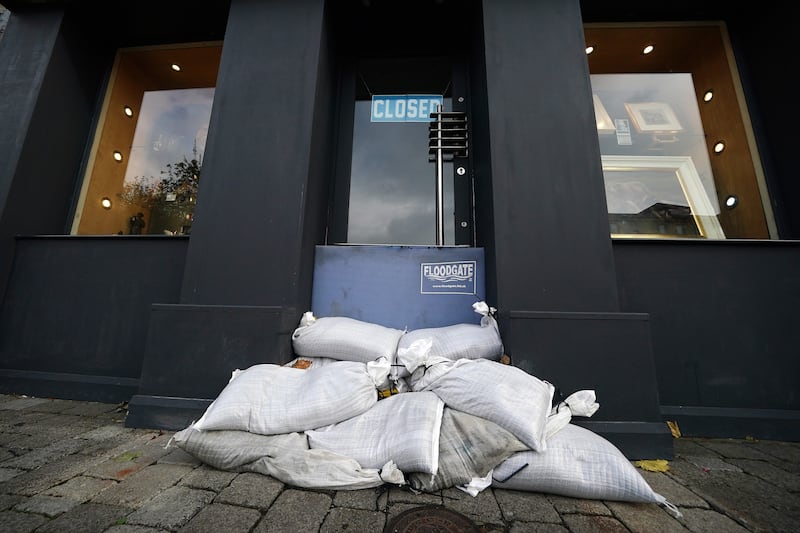 Sandbags and a flood-defence barrier in a shop doorway in Galway city centre. Photograph: Brian Lawless/PA Wire