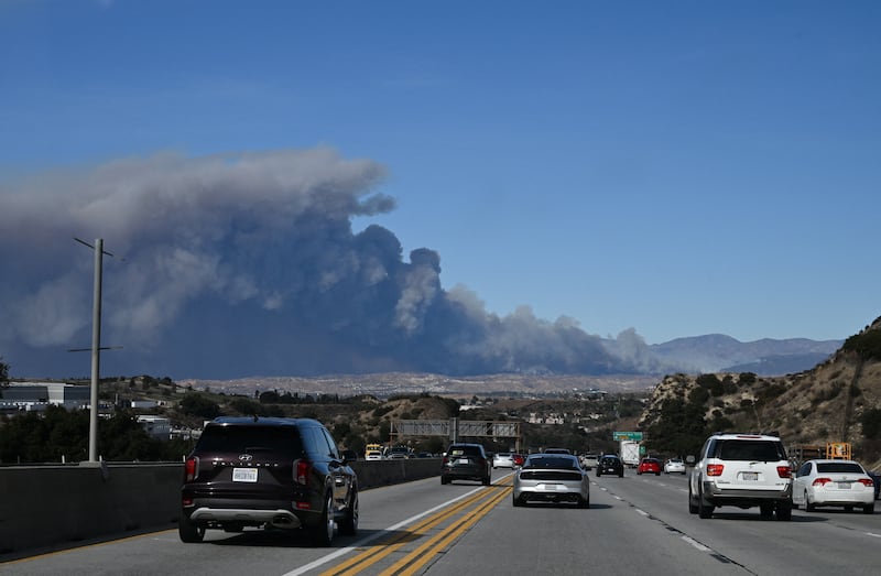 A plume of smoke from the new Hughes fire is seen behind the California State Route 14 highway from Santa Clarita, California, on January 22nd. Photograph: Robyn Beck / AFP