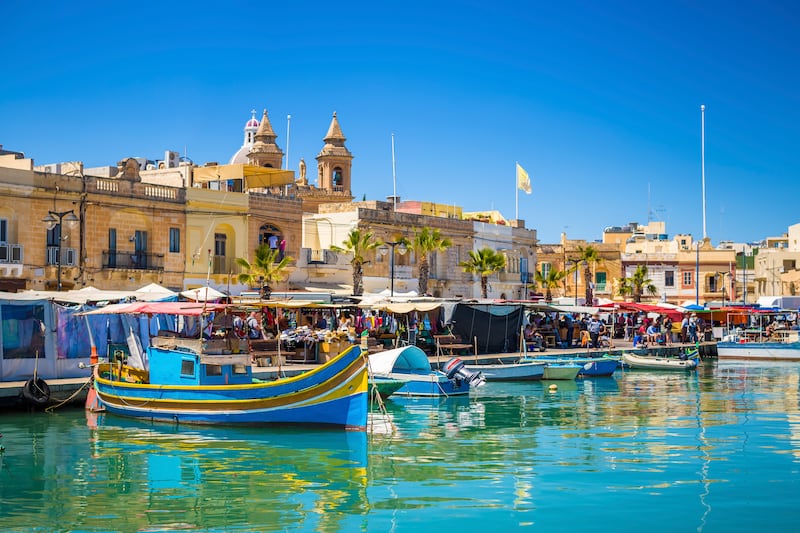 Marsaxlokk market with traditional Luzzu fishing boats. Photograph: iStock