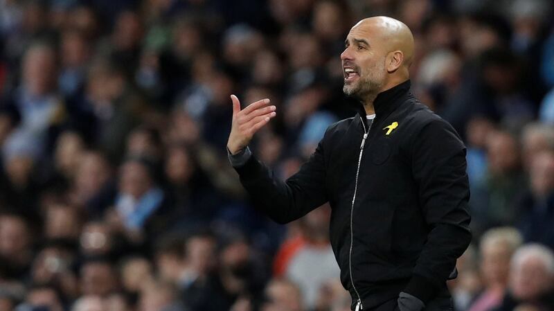 Pep Guardiola again wore a yellow ribbon in support of Catalan politicians who have been jailed for pushing for independence in Spain. Photograph: Reuters