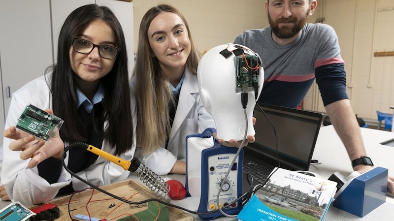 Teacher Rory Coote with students Sophie Creedon and Lydia Kelleher from St Mary’s Secondary School, Mallow, Co Cork who are showcasing their project, an investigation into sports-related cranial impacts and the design and development of wearable technology to better enable the measurement and recording of such head impacts. Photograph: Fennell Photograph