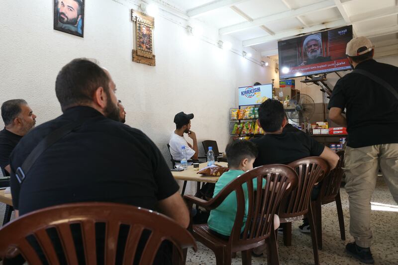 People watch a televised speech by Hizbullah's deputy chief Naim Qassem in a cafe in Beirut's southern suburbs on September 30th. Photograph: Ibrahim Amro/AFP via Getty