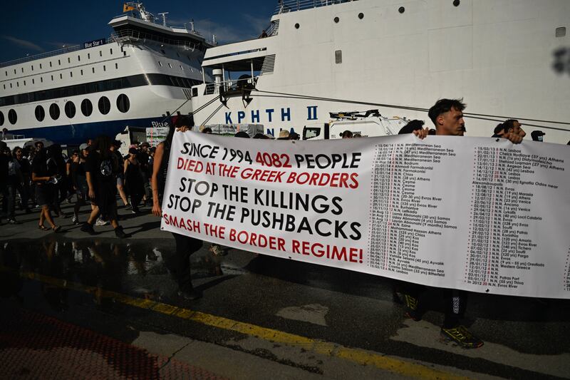 Protesters carry a banner listing the cases of migrants' deaths during a protest march to Frontex and Hellenic Coastguard headquarters in the port of Piraeus near Athens. Photograph:  Louisa Gouliamaki/AFP via Getty Images