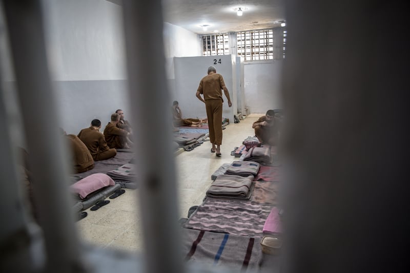 Zakaria Mohammed Ismail walks through his cell in Panorama Prison