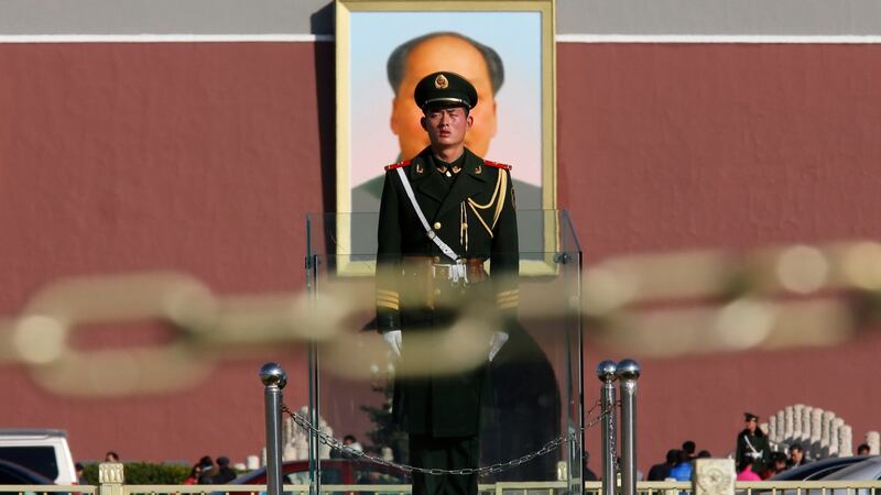 A  soldier stands guard   on Tiananmen square next to the Great Hall of the People where the Chinese Communist Party plenum is  held. A unit of the party oversees universities in China which specialise in ethnic studies and  education of students from minority groups. Photograph: Reuters