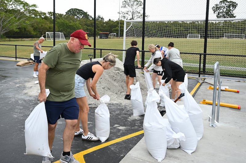 Members of Eastern Suburbs Soccer Club fill sandbags at Heath Park on March 5th, 2025, in Brisbane, Australia. Photograph: Albert Perez/Getty Images