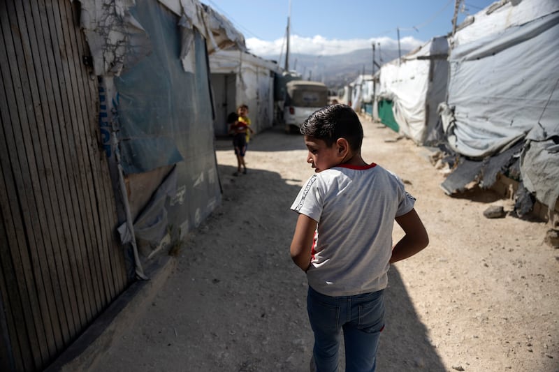 Yehia Ak Hamdo (9) walks to the classroom at the Makani centre in an informal tented settlement in Saadnayel, in Lebanon’s Bekaa valley. His father was killed after he returned to the family's Syrian farm in 2009, leaving his mother and siblings struggling to survive. Photograph: Chris Maddaloni/The Irish Times