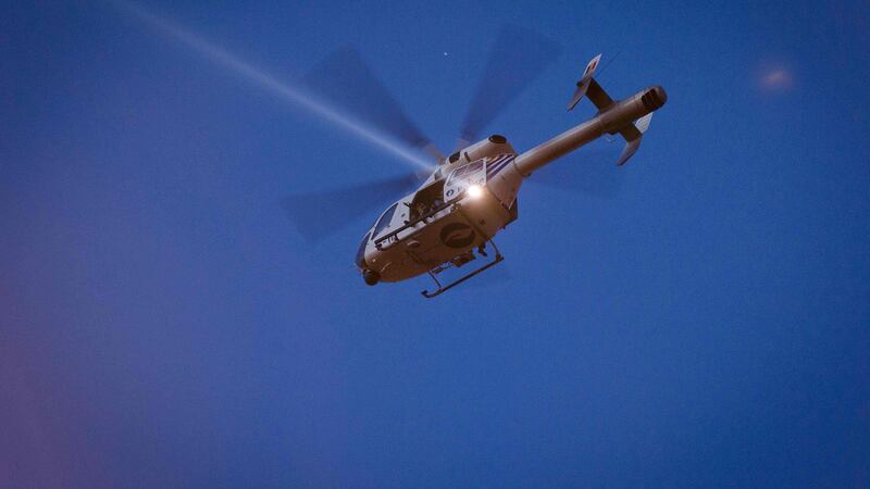 A police helicopter shines light on roofs during searches in Schaarbeek in Brussels, Belgium. Photograph: James Arthur Gekiere/AFP/Getty Images