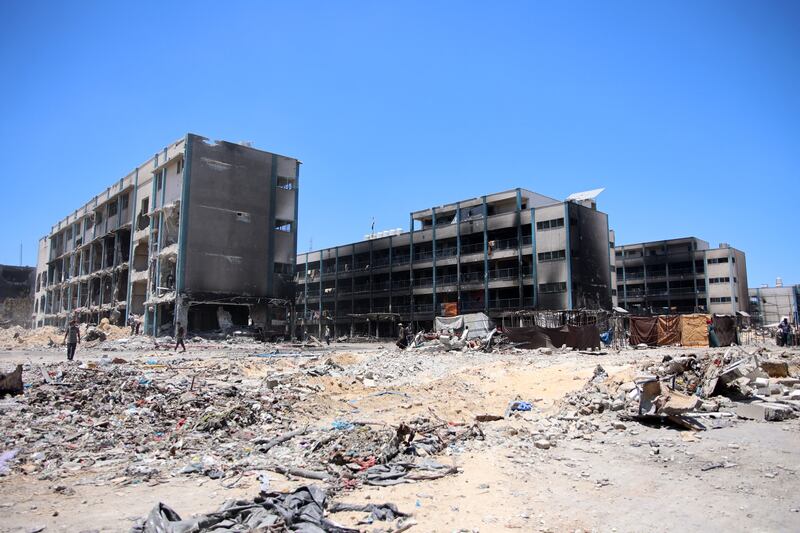 Palestinians walk in front of a damaged UN-run school in the Jabilia refugee camp in the northern Gaza Strip on Friday. Photograph: Omar al-Qattaa/AFP via Getty