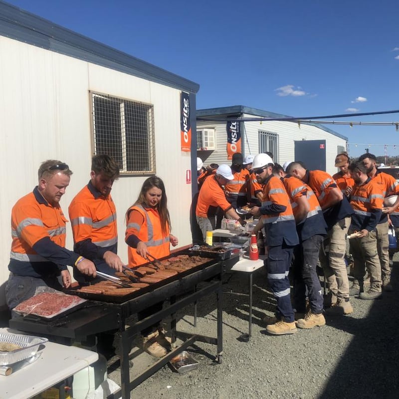 Ollie Gordon (left) cooking for his TradeConnex employees