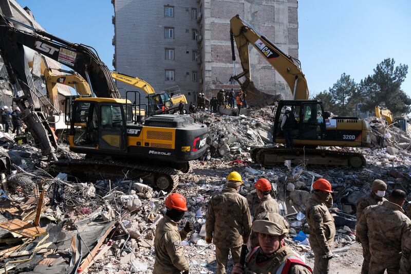 Volunteers and rescue teams work at a ruined building on February 11th in Adiyaman, Turkey. Photograph: Mehmet Kacmaz/Getty