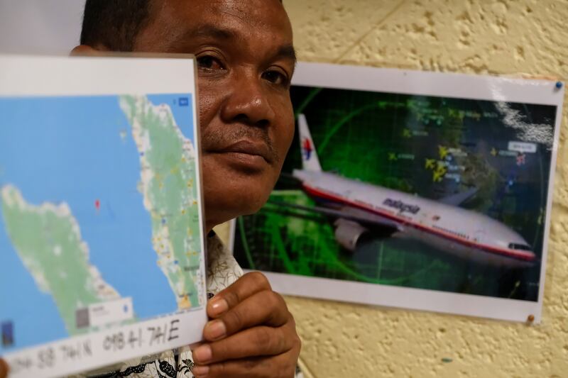 Rusli Khusmin, a fisherman from Indonesia, shows a map of the location where he believes flight MH370 crashed into the Sumatra Indonesia Sea. Rusli and his crew members said that, in March 2014, they witnessed a damaged aircraft, black smoke and the smell of acidic fumes before the aircraft crashed.  Photograph: Mohd Samsul Mohd Said/Getty Images