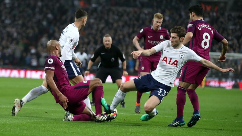 Ben Davies could have seen red for this tackle on Vincent Kompany. Photo: Adam Davy/PA