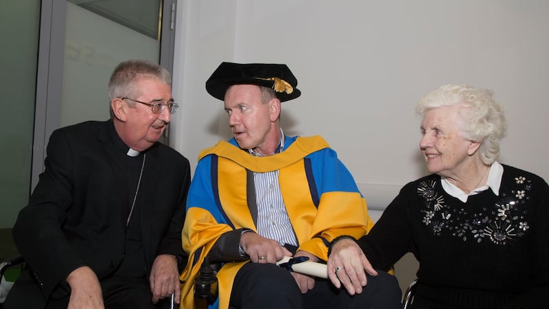 Fr Tony Coote was conferred with an honorary doctorate of science by UCD. He is pictured here with Archbishop of Dublin Dr Diarmuid Martin and his mother Patricia. Photograph: Colm Mahady/Fennells