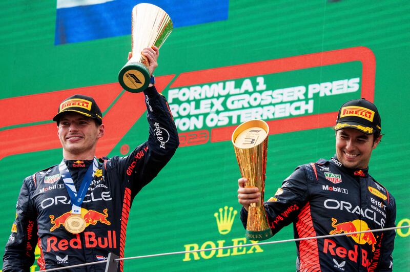 Austrian Grand Prix winner Max Verstappen and Sergio Perez, who came third, celebrate on the podium after the F1 Austrian Grand Prix. Photograph: Georg Hochmuth/APA/AFP via Getty