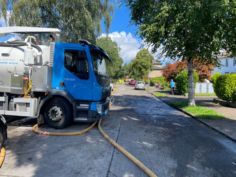 Workers from Dublin Fire Brigade and Dublin City Council drain an area in Clontarf, Dublin that was hit by flooding. Photograph: Gráinne Ní Aodha/PA Wire