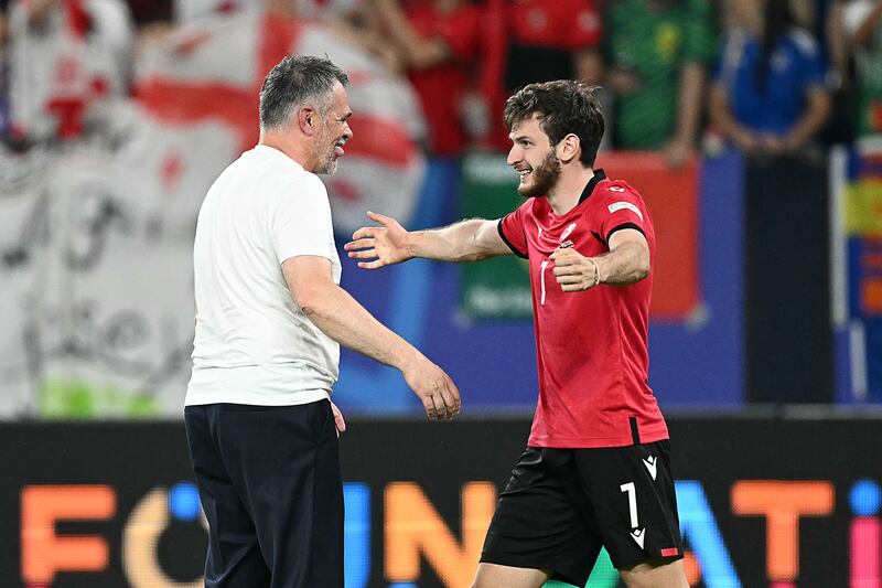 Georgia's French head coach Willy Sagnol (left) and Georgia's forward Khvicha Kvaratskhelia celebrate after beating Portugal. Photograph: Patricia De Melo Moreira/AFP via Getty Images