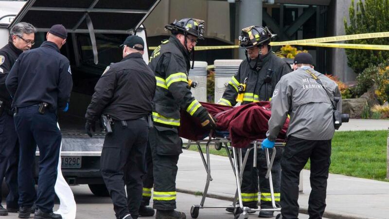 Authorities remove a body from the wreckage of a KOMO News helicopter which crashed near the Space Needle in Seattle. Photograph: David Ryder/Reuters.