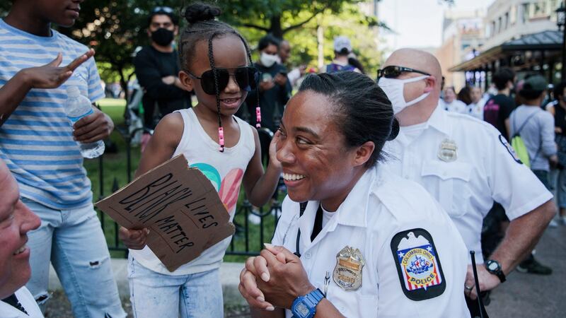 Police officer Kiara Husband chats with Loyalty Jones (6) of Columbus, Ohio, before police and protesters marched together in Columbus, Ohio  on Tuesday. Photograph: Joshua A Bickel/The Columbus Dispatch via AP