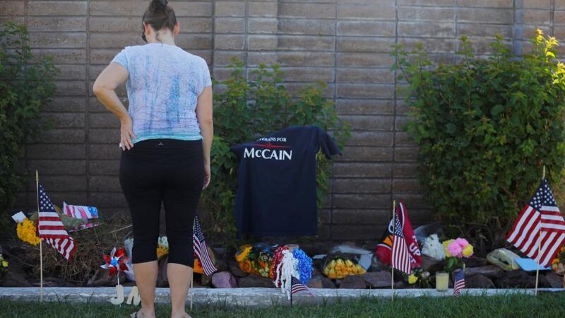 A woman pays her respects at a memorial outside the funeral home where the body of the late US senator John McCain rests in Phoenix, Arizona. Photograph: Brian Snyder/Reuters