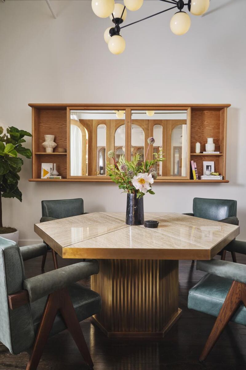 Meeting room with Travertine marble table to seat six with a TV unit on the wall. Photograph: Thomas Loof