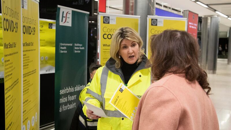 Staff handing out advice leaflets at the Coronavirus/COVID-19  stand in Dublin Airport. Photograph:  Colin Keegan, Collins